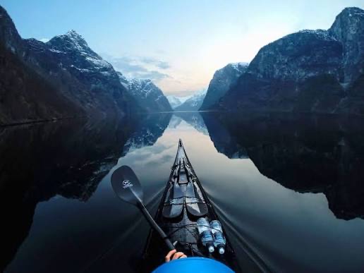GoPro POV — kayaking a mirror-calm fjord at dawn