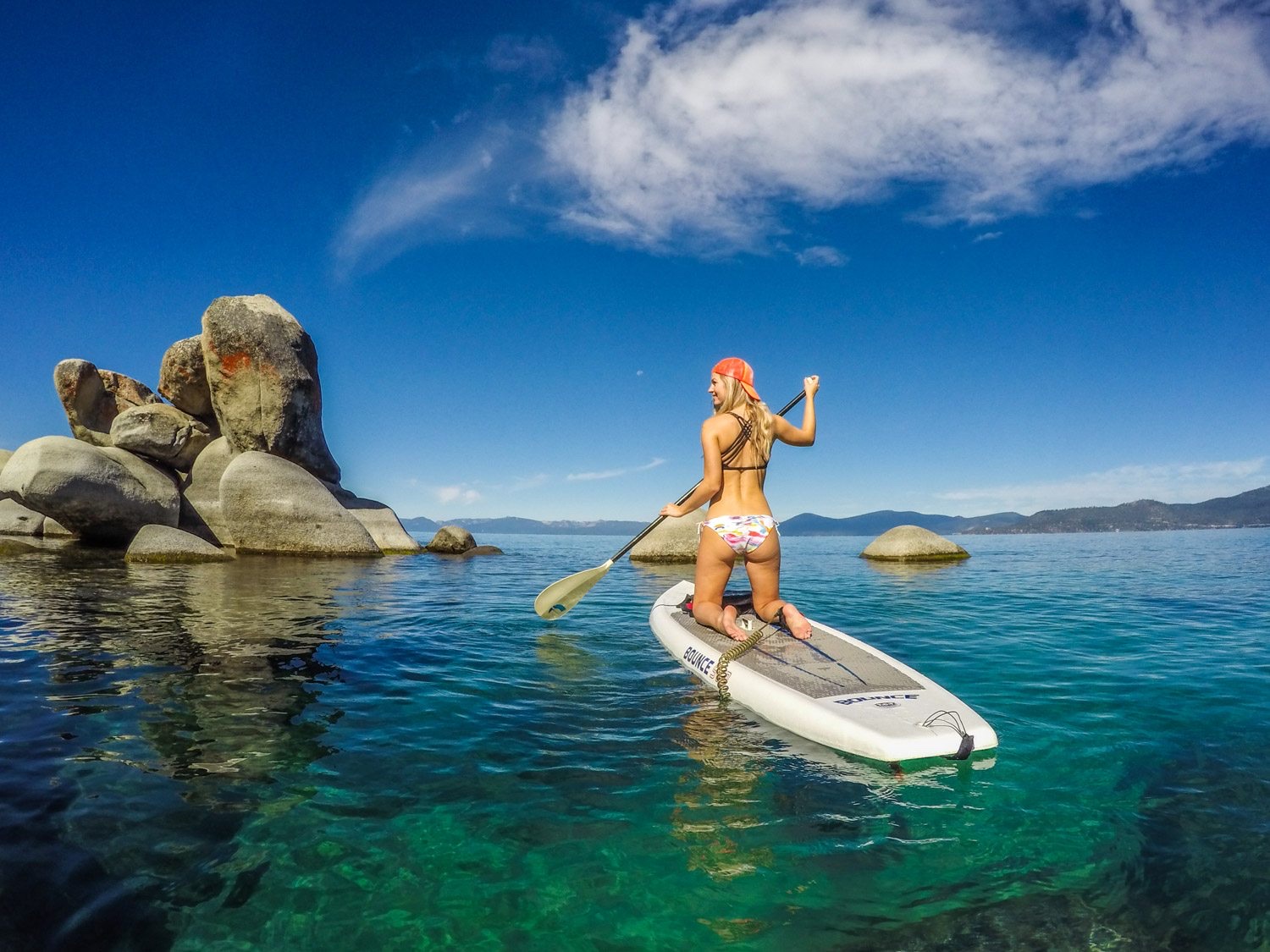 GoPro POV — paddleboarding on a clear alpine lake